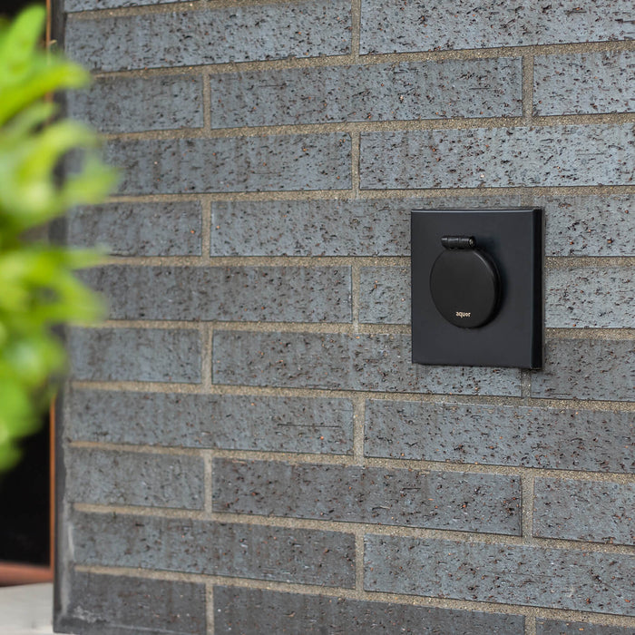 A matte black v1+ debris cover shown on brick with a mounting box.|47730978717946