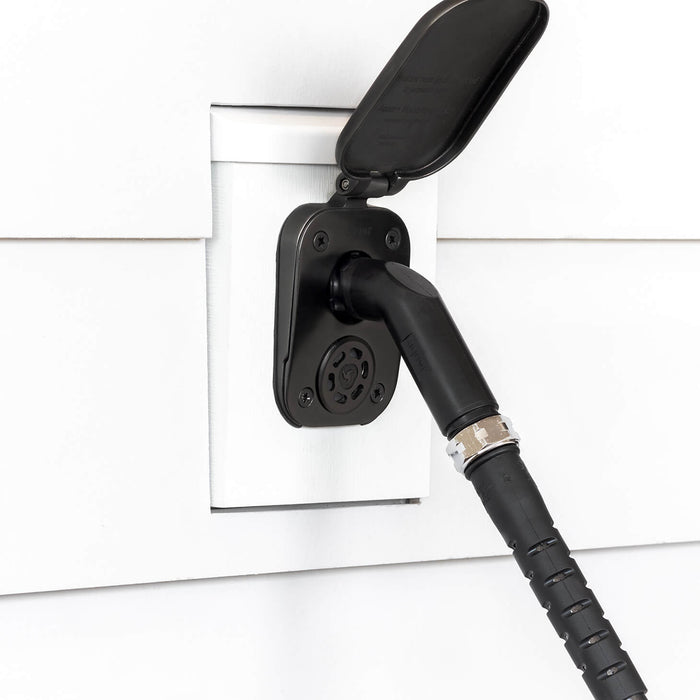 A jet black angled hose connector connected to a matte black house hydrant v2+ installed on white lap siding with a mounting block.|42444149555450