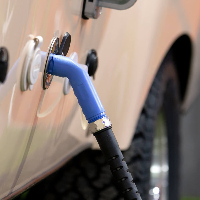 An aquor blue angled hose connector plugged in a marine deckwash installed on a van.|42444149522682