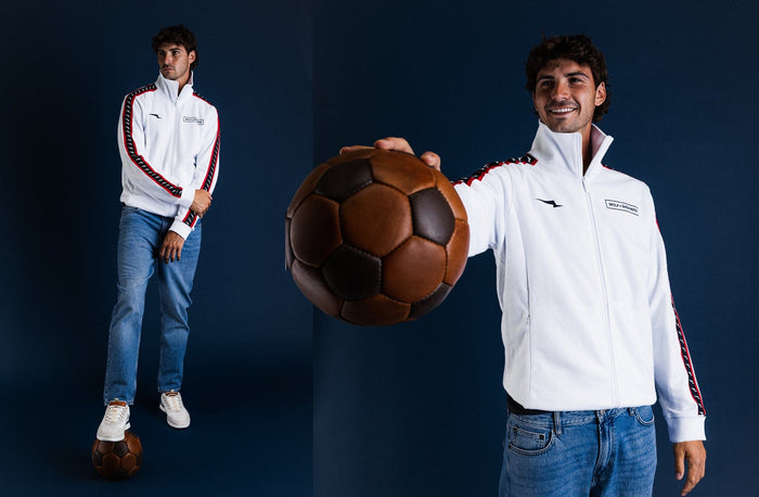 Americana // Two men in white Crossover Track Jackets, one holding a soccer ball