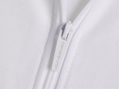 Americana // Close-up of zipper pull with Wolf & Shepherd branding
