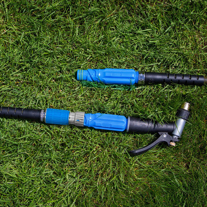 A blue hose adapter sits connected in the grass.|42444323553530