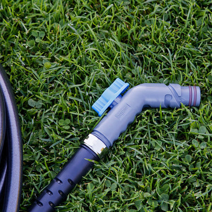 Slate gray removable faucet hose connector and hose laying in the grass.|42444252545274