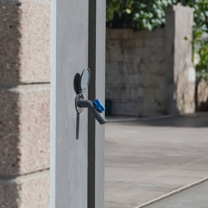 A slate gray removable faucet connector plugged into a slate gray house hydrant v1+.|42444252545274