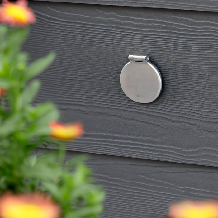 A brushed stainless v1+ debris cover shown on gray lap siding.|47730978685178