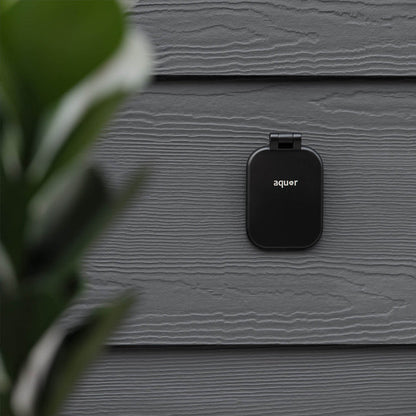 A matte black v2+ debris cover shown on gray lap siding.|47730985828602