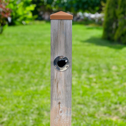 A universal hydrant installed into a singular wooden post.